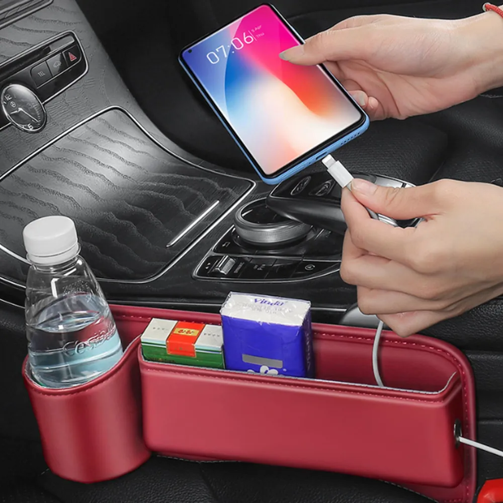 A seat gap organiser fitted beside a car seat, holding a phone and a bottle